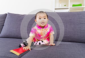 Chinese baby touching red pocket