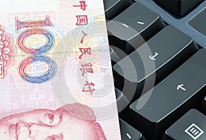 Chinese banknote on the computer keyboard