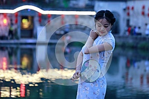 Chinese beauty in cheongsam enjoy free time