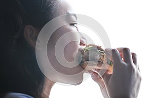 Chinese beauty girl eat hamburger, side face closeup