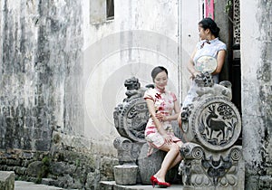 Chinese beauty girlfriends in cheongsam enjoy free time