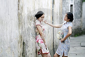 Chinese beauty girlfriends in cheongsam enjoy free time