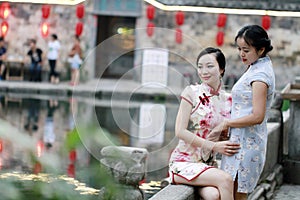 Chinese beauty girlfriends in cheongsam enjoy free time