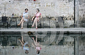 Chinese beauty girlfriends in cheongsam enjoy free time