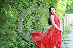 Chinese beauty sit on an ancient bridge enjoy vacation