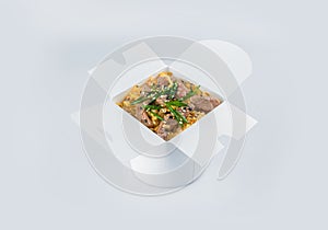 Chinese beef rice in white carton takeaway delivery box. Isolated on background