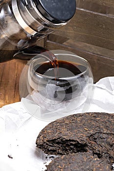 Chinese black pu-erh tea in a glass cup