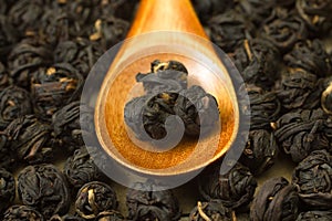 Chinese black tea leaf balls inside wooden spoon