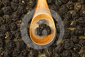 Chinese black tea leaf balls inside wooden spoon