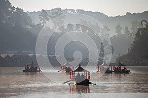 Chinese boating in the morning and fog floating on the water