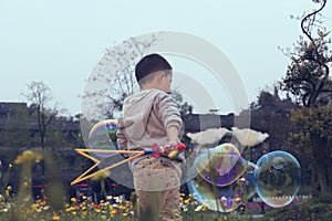Chinese boy playing soapbubbles