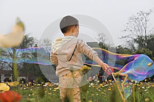 Chinese boy playing soapbubbles