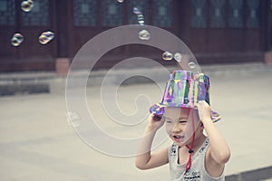 Chinese boy playing soapbubbles