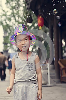 Chinese boy playing soapbubbles