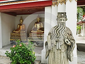 Chinese and buddha statues at wat pho temple in bangkok