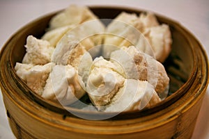 Chinese buns cooked in a traditional bamboo steamer.