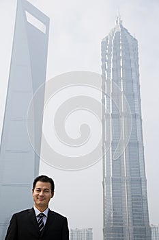 Chinese businessman near skyscrapers