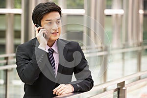 Chinese Businessman Outside Office On Mobile Phone