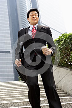 Chinese Businessman Rushing Down Steps