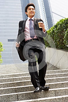 Chinese Businessman Rushing Down Steps