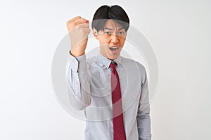 Chinese businessman wearing elegant tie standing over isolated white background angry and mad raising fist frustrated and furious