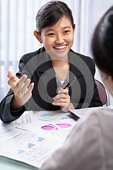 Chinese businesswoman talking to her client