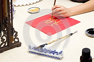 chinese calligraphy Master writing new year golden character Fu means Blessing, Good Fortune, Luck