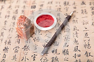 Chinese calligraphy and a seal and ink pad and a carving knife