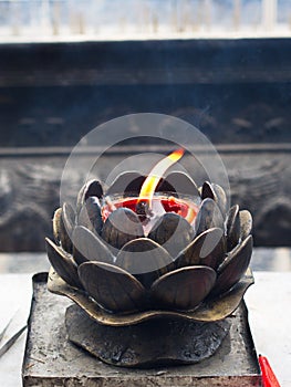 Chinese Candle Flame with Candle Oil Holder in Shaolin Temple. Dengfeng City, Zhengzhou City, Henan Province, China, 18th October