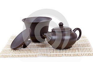 Chinese ceramic tea set bamboo mat isolated on white