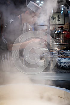 Chinese chef preparing hot food