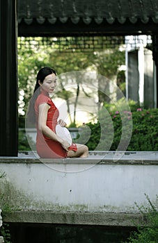 Chinese cheongsam model in Chinese classical garden