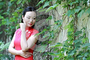 Chinese cheongsam model play in a famous garden