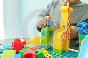 Chinese child boy hands playing colourful blocks toy