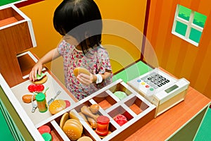 Chinese children role-playing at burger store.