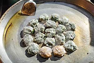Chinese chives are wrapped in batter and then fried in a pan and sold in the market.