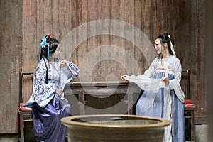 Chinese classic woman in Hanfu dress . chat with each other