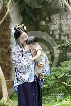 Chinese classic woman in Hanfu dress enjoy free time with baby and close friends