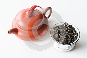 Chinese clay teapot and bowl with tea on a white background
