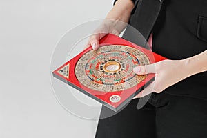 Chinese compass Lopan for Feng Shui technique in female hands is