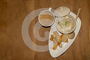 Chinese congee with Chinese breadstick and coffee as