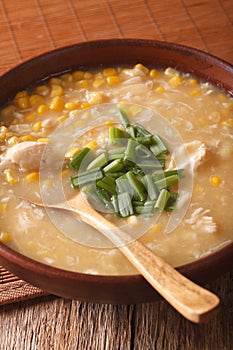 Chinese corn and chicken soup in a bowl close-up. Vertical