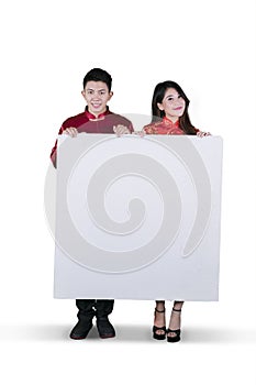 Chinese couple holding a blank whiteboard