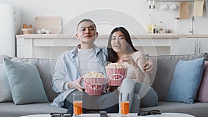 Chinese Couple Watches Movie On TV Eating Popcorn At Home