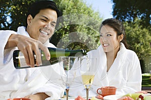 Chinese Couple Wearing Bathrobes Drinking Champagne