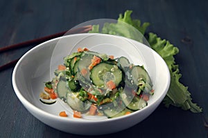 Chinese cucumber salad on the white plate Close up