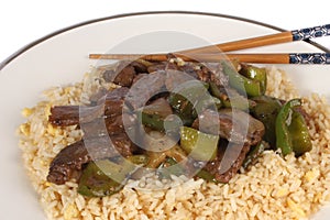 Chinese Cuisine, beef and black bean sauce with egg fried rice against a white background