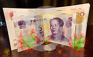 Chinese currency banknotes and coins close up on a leather table in a hotel room in Beijing