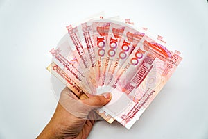 Chinese currency, money, yuan, money fan in hand on a white background, isolate