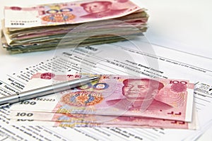 Chinese currency, pen and tax form